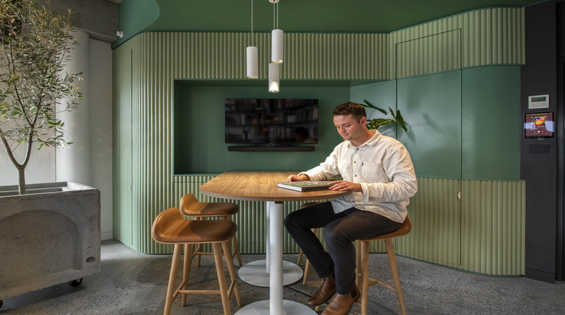 man reading in new SDA office at table